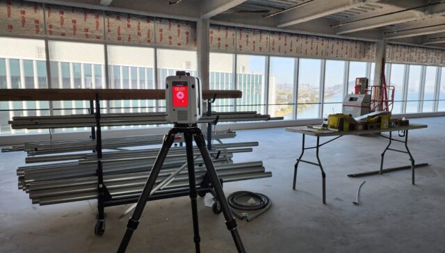 Field operator scanning retail interior for architectural and MEP coordination.