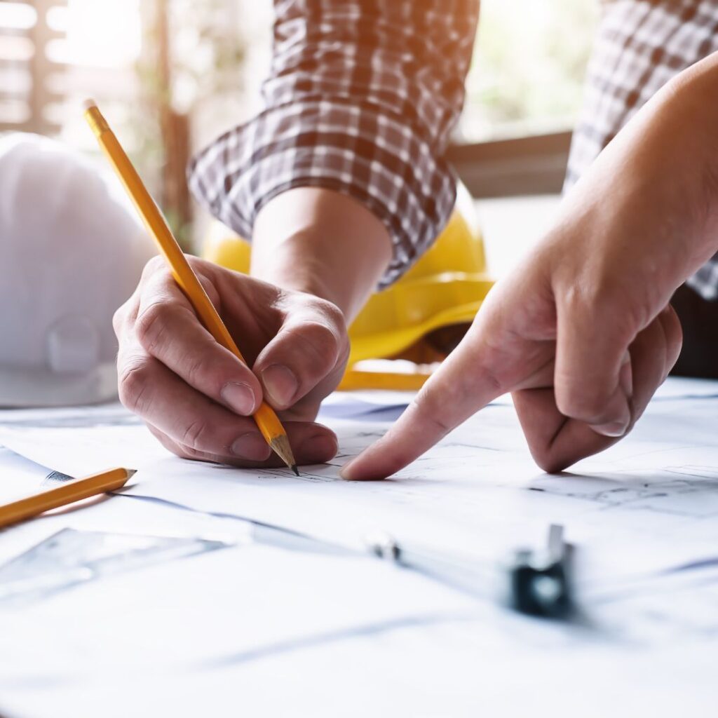 Architect hand sketching existing conditions during manual field measurement for renovation planning