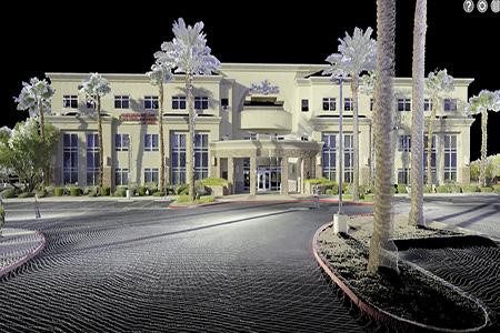 Dense 3D point cloud data capture of a commercial building exterior showing millions of laser scan measurement points in a colorized digital representation